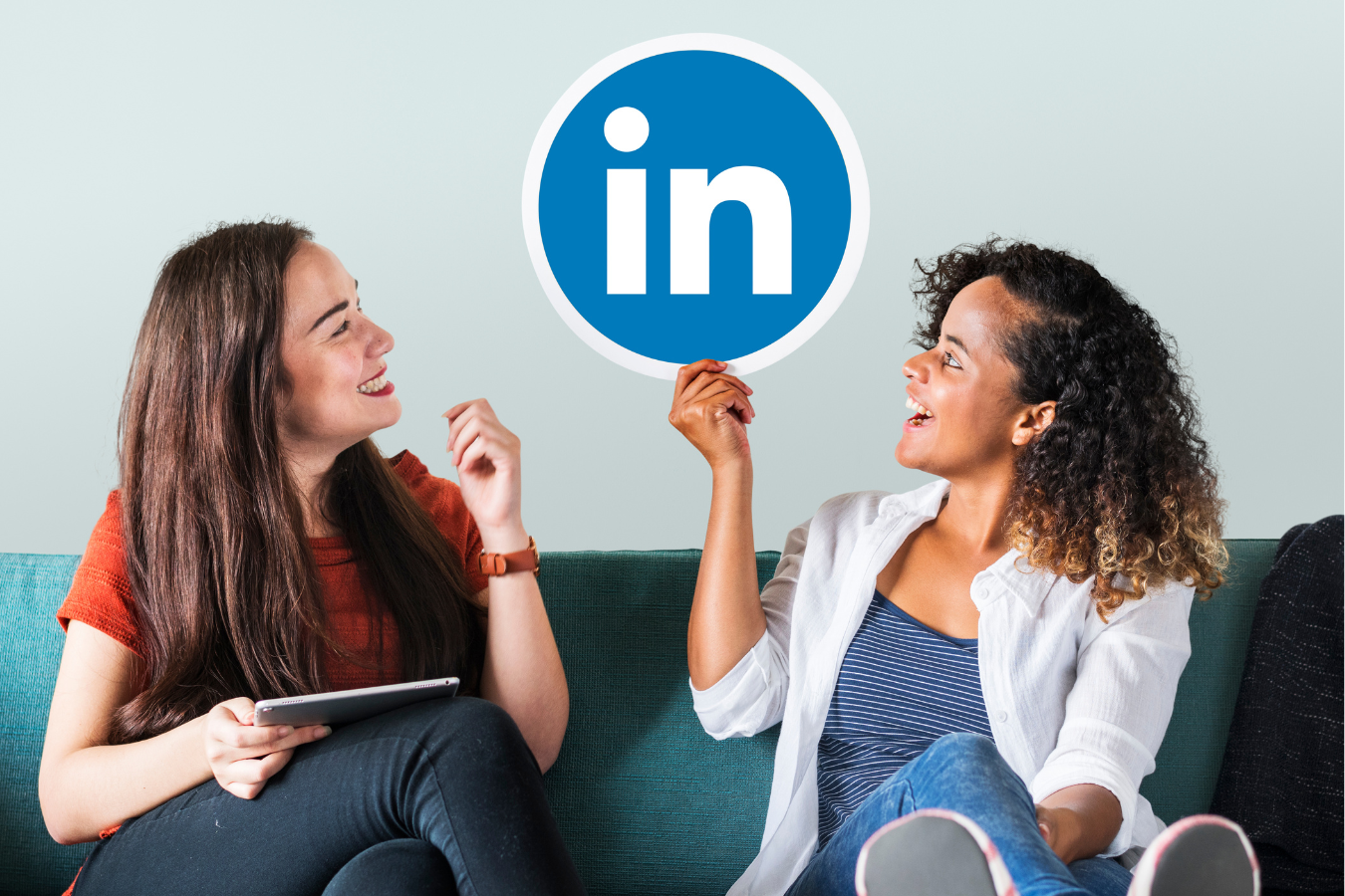 Two women holding a LinkedIn logo